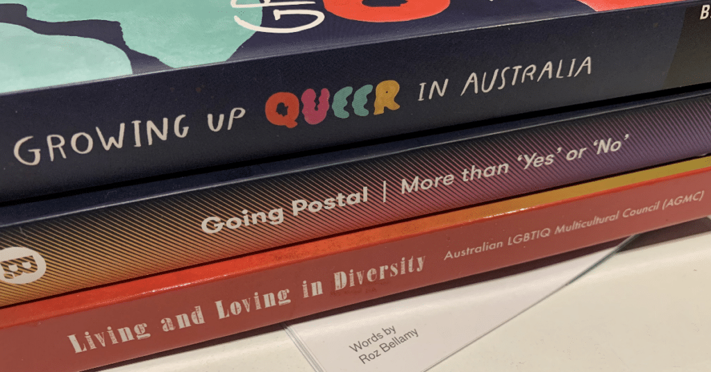 Pile of books displaying spines 'Growing Up Queer in Australia', 'Going Postal: More than "Yes" or "No"', and 'Living and Loving in Diversity'